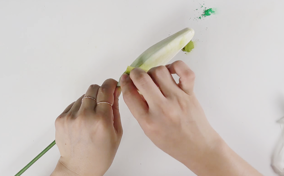 Shaping and arranging the six white crepe paper petals to complete a realistic lily flower