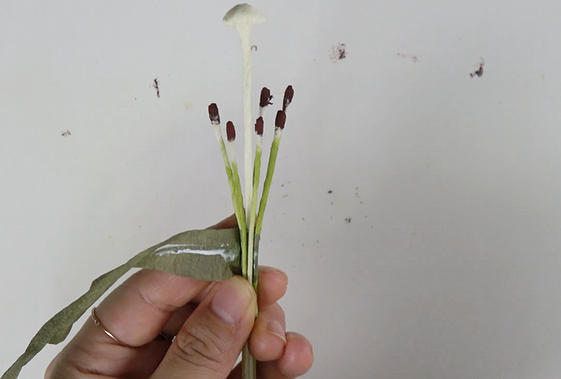 Bending white floral wire to create the center structure of a paper lily