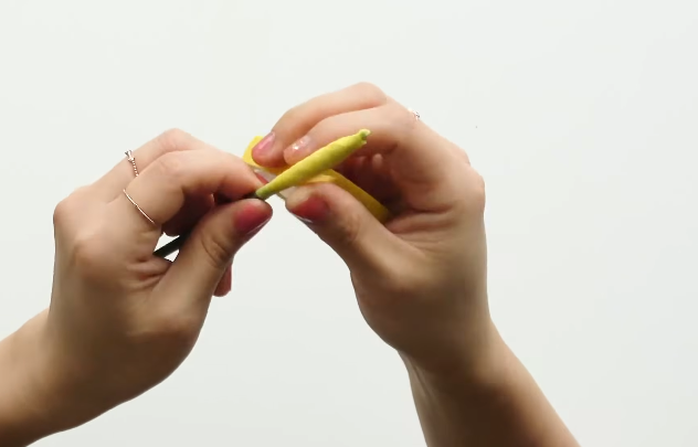 Wrapping the floral stem with yellow floral tape to make the calla lily center
