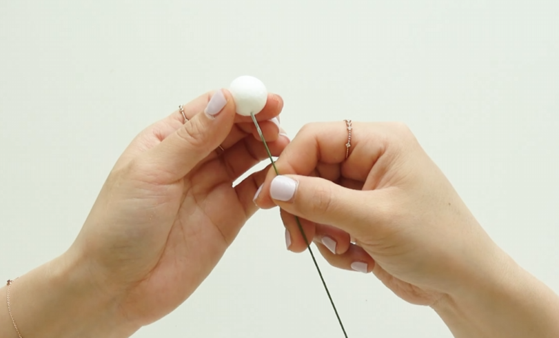 Attaching a Styrofoam ball to floral wire to make a plum blossom bud