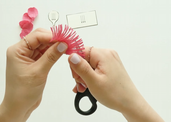 Curling crepe paper stamens backward with scissors