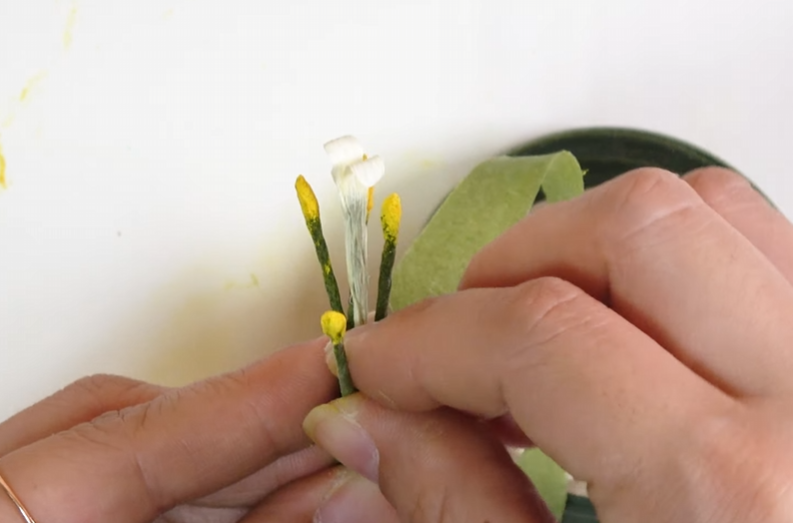 Attaching the prepared stamens around the lisianthus pistil