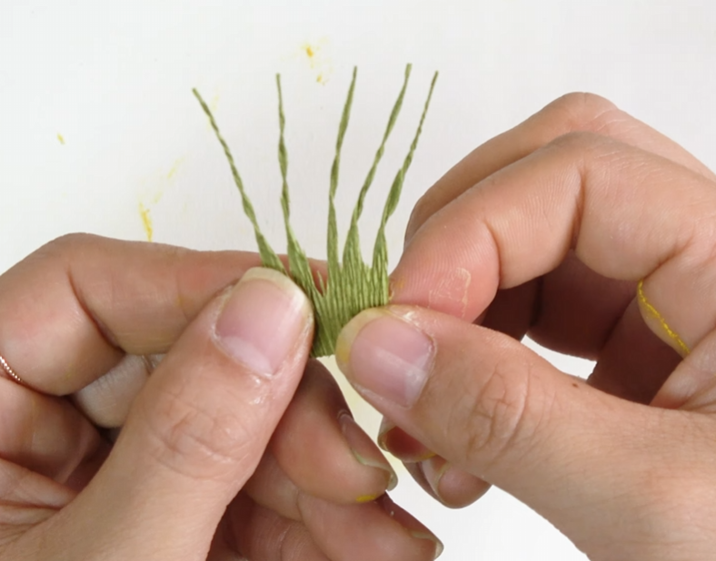 Preparing the green crepe paper calyx pieces for the lisianthus flower