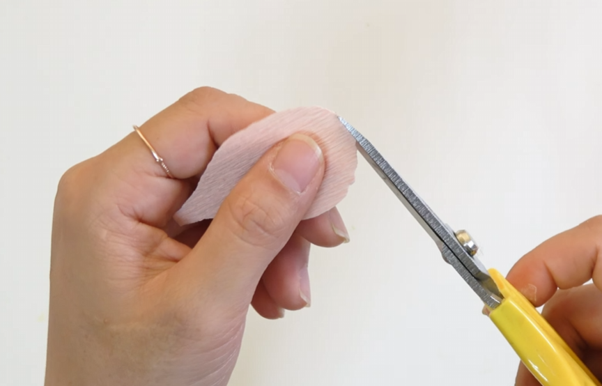 Trimming the top edge of a crepe paper lisianthus petal into a wavy shape