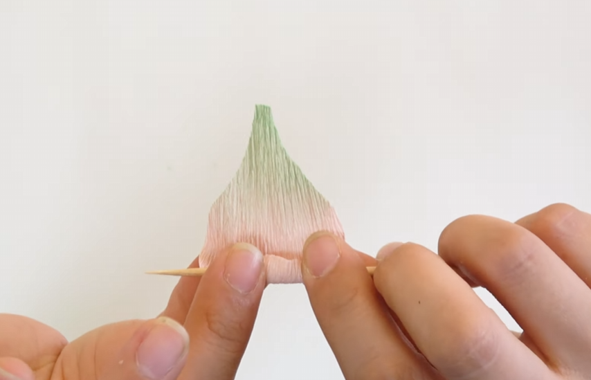 Curling the edge of a crepe paper lisianthus petal with a wooden skewer