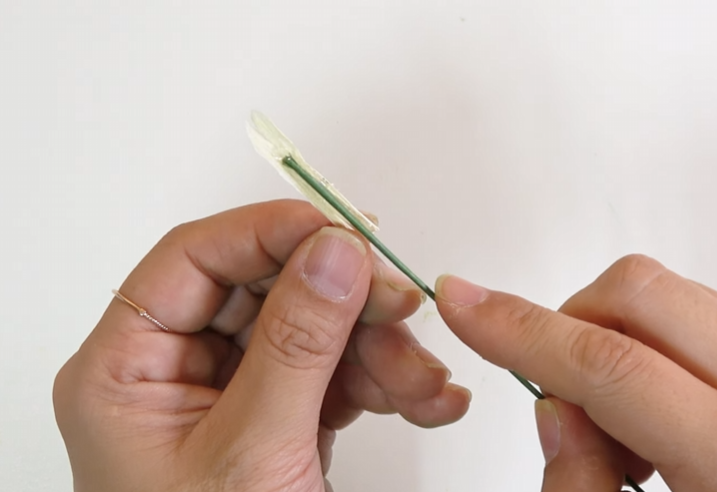 Attaching the pale yellow crepe paper pistil to green floral wire