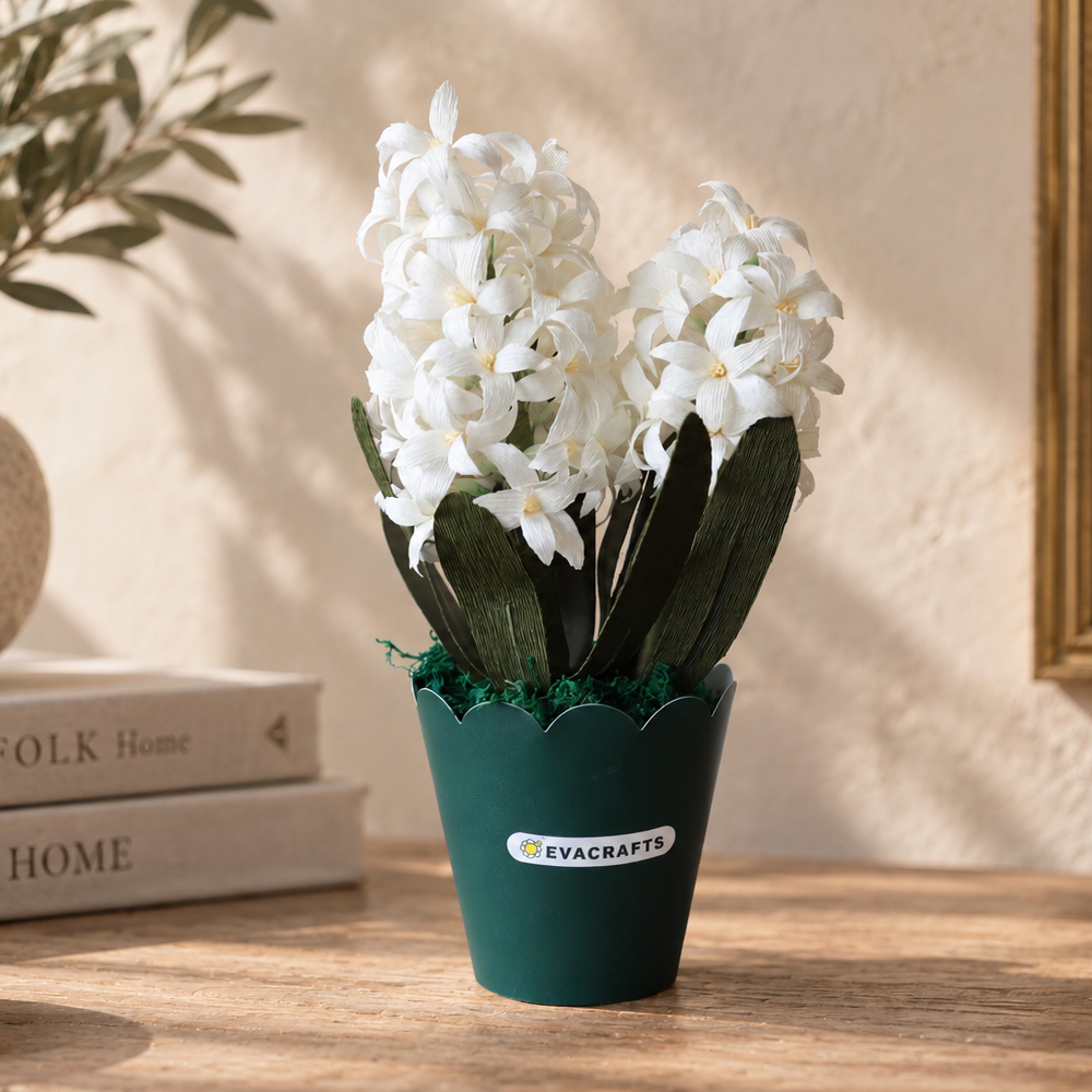 Realistic white crepe paper hyacinth flowers in a decorative green pot