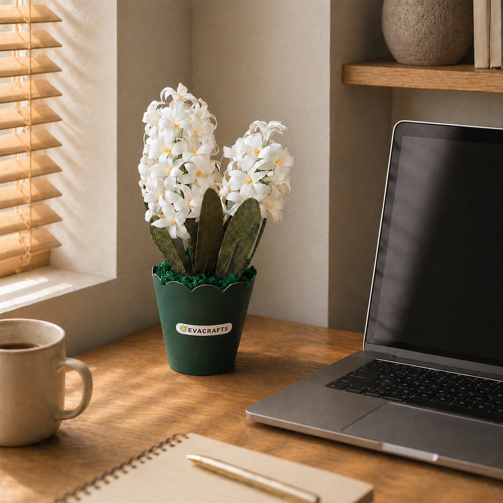 White crepe paper hyacinth flowers in a green pot decorating a cozy home office desk