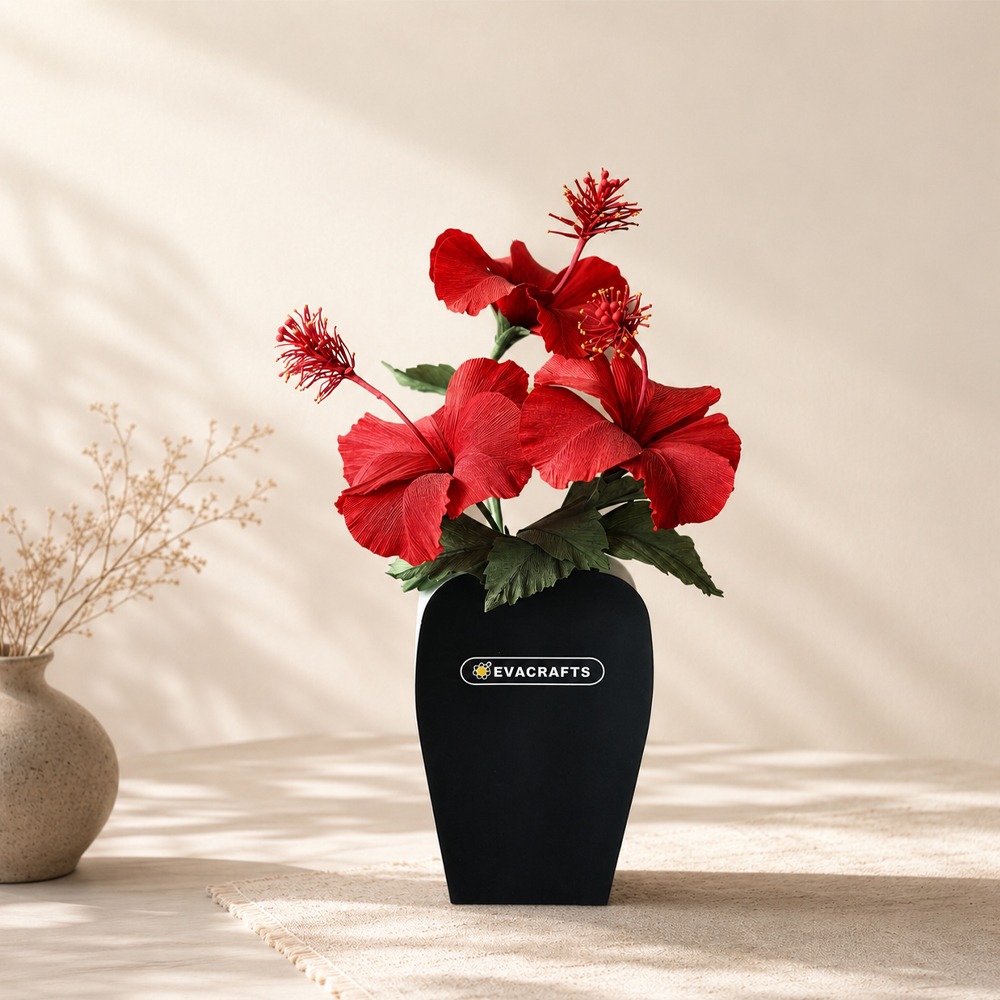 Realistic red tropical hibiscus flower arrangement handmade from crepe paper in a black vase