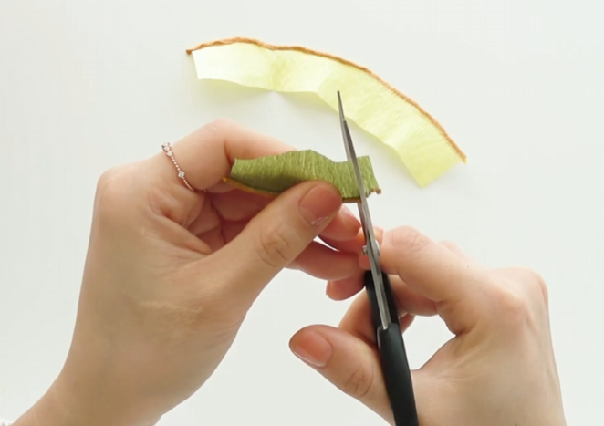 Cutting fine fringe into the green crepe paper stamen for a realistic flower center