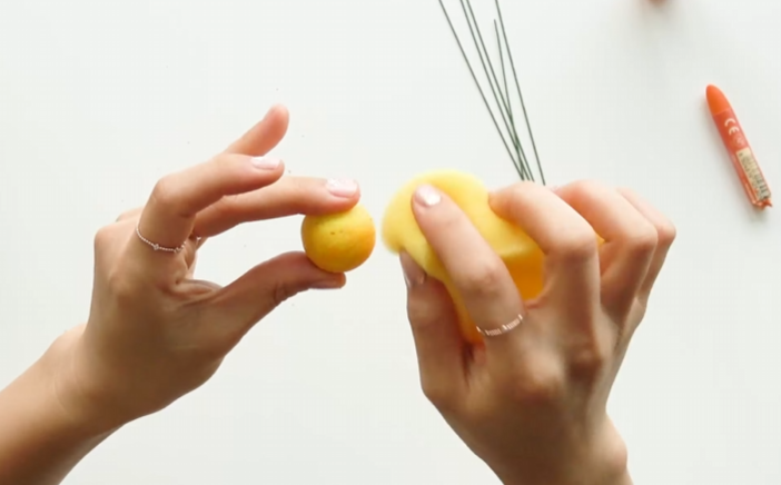 Adding floral wire between crepe paper leaf pieces to make a realistic kumquat leaf