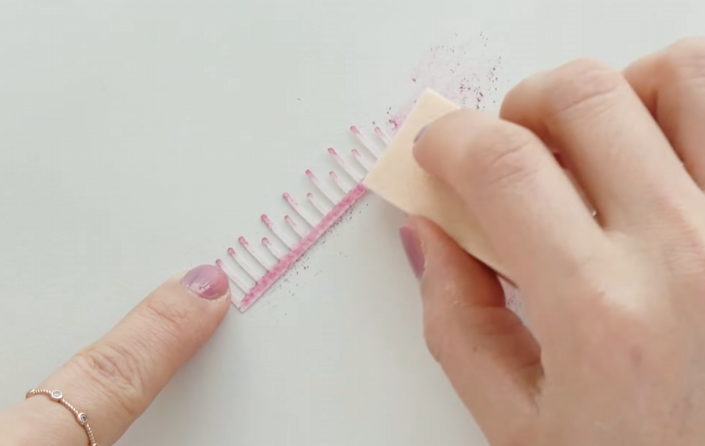 Adding pink pastel powder to the edges of paper cherry blossom stamen pieces