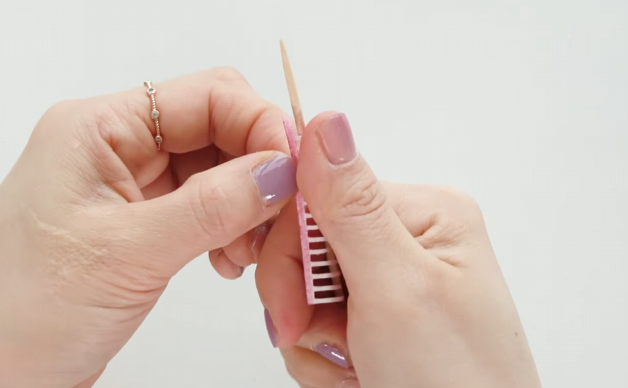 Curling paper cherry blossom stamens backward with a thin wooden stick