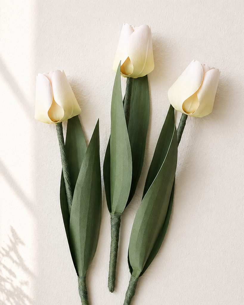 Paper tulip bouquet with three soft pink tulips wrapped in kraft paper with jute twine