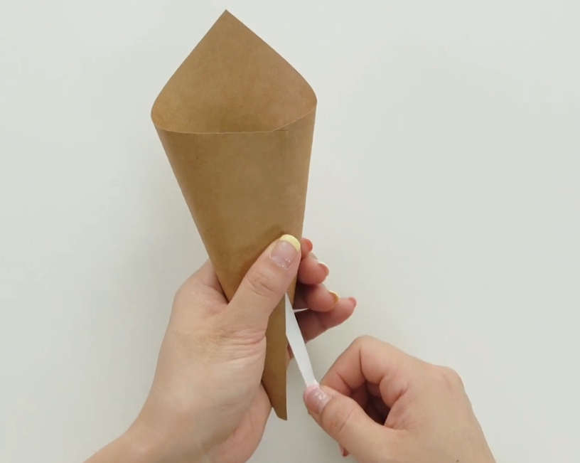 Rolling kraft paper into a cone for the paper tulip bouquet