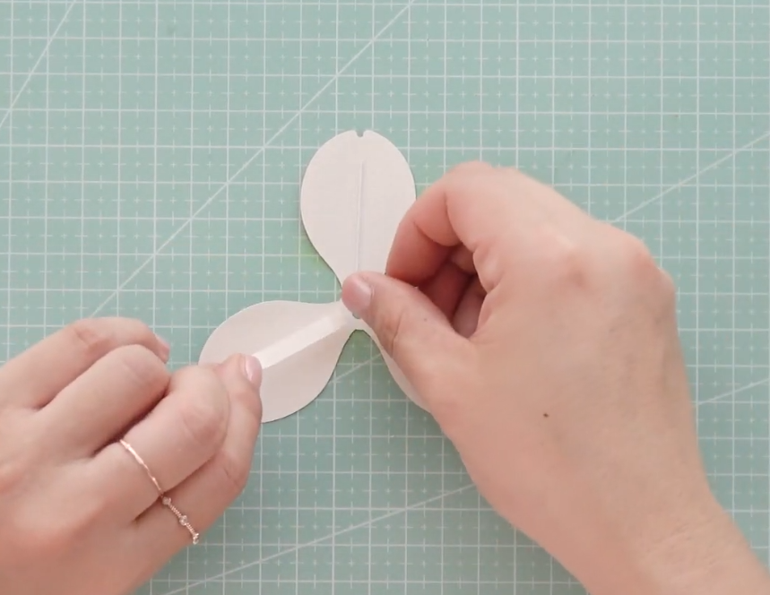 Attaching floral wire to the center of paper tulip petals