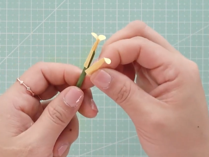 Attaching three yellow pistil pieces to the floral stem