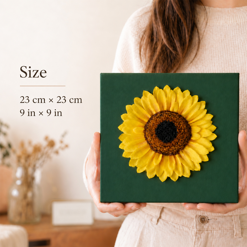 23 cm crepe paper sunflower wall art on a green canvas held in both hands