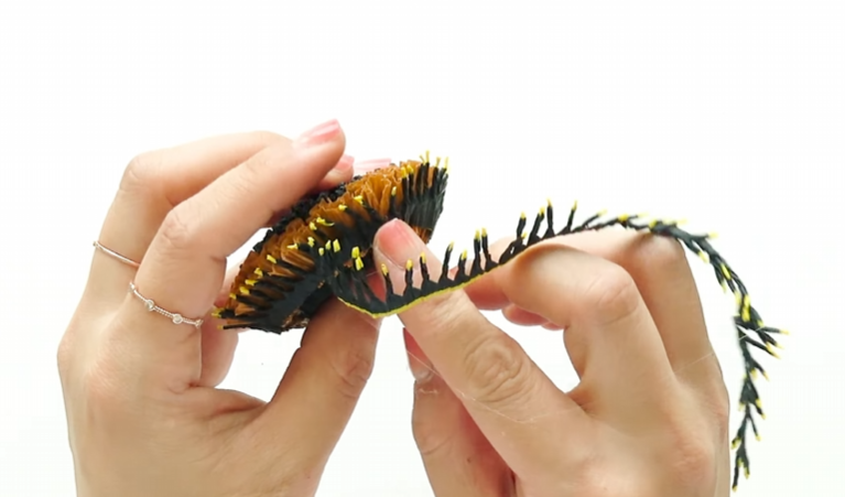 Wrapping black and yellow stamen fringe around the crepe paper sunflower center