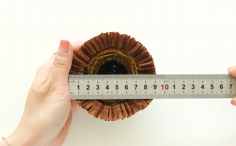 Measuring the finished crepe paper sunflower center to about 9 cm