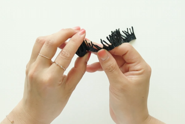 Connecting black crepe paper stamen strips to form the center of the sunflower