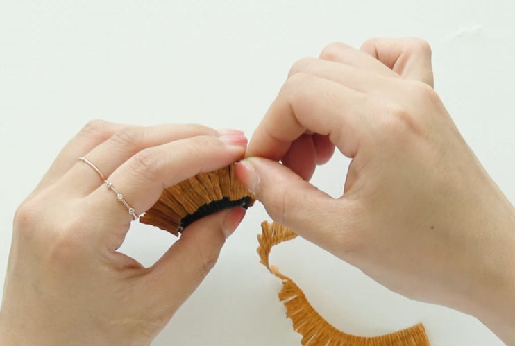 Wrapping light brown crepe paper fringe around the sunflower center