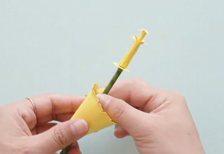 Rolling and attaching the yellow trumpet-shaped corona for the paper daffodil