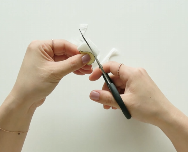 Cutting white crepe paper petals with a plum blossom template