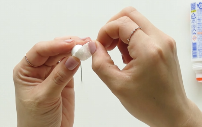 Covering a Styrofoam bud with stretched white crepe paper petals